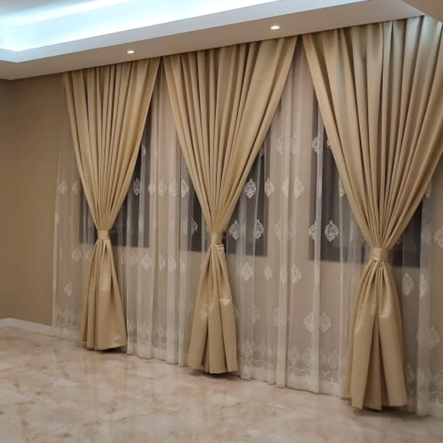 Champagne curtains with embroidered sheers in a finished room